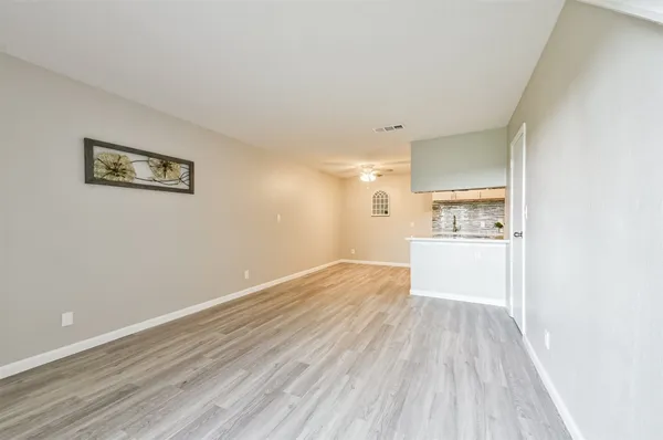 a view of a kitchen with wooden floor