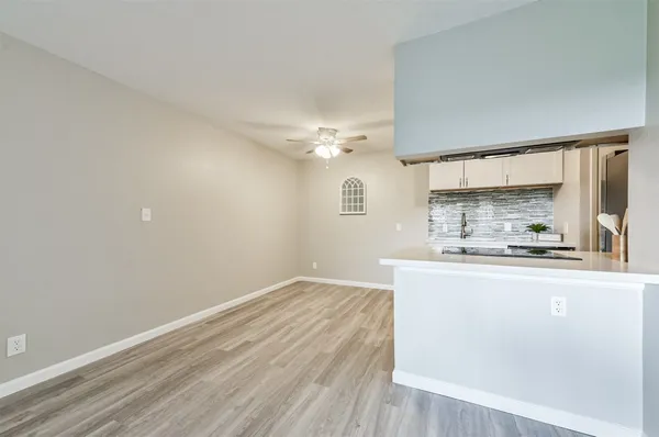a view of a kitchen with a sink and wooden floor