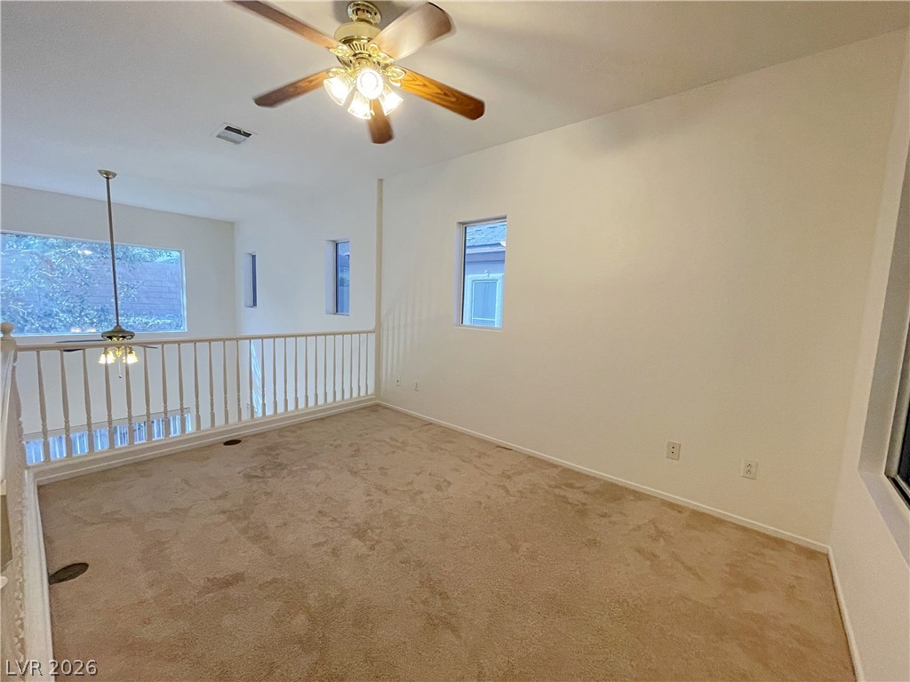 691 Principle Point Avenue Henderson, NV 89012 - Photo 15 of 30 A versatile open loft space featuring a ceiling fan and ample natural light.