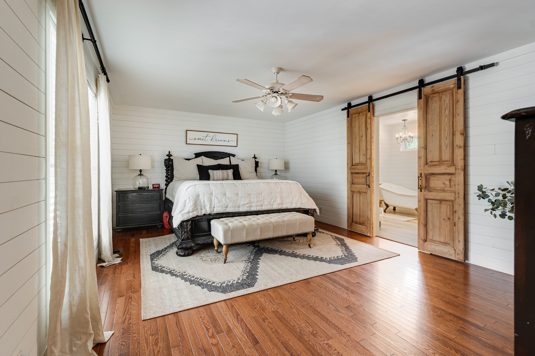 122 West Harper Road Portland, TN 37148 - Photo 26 of 74 a bedroom with a bed and wooden floor