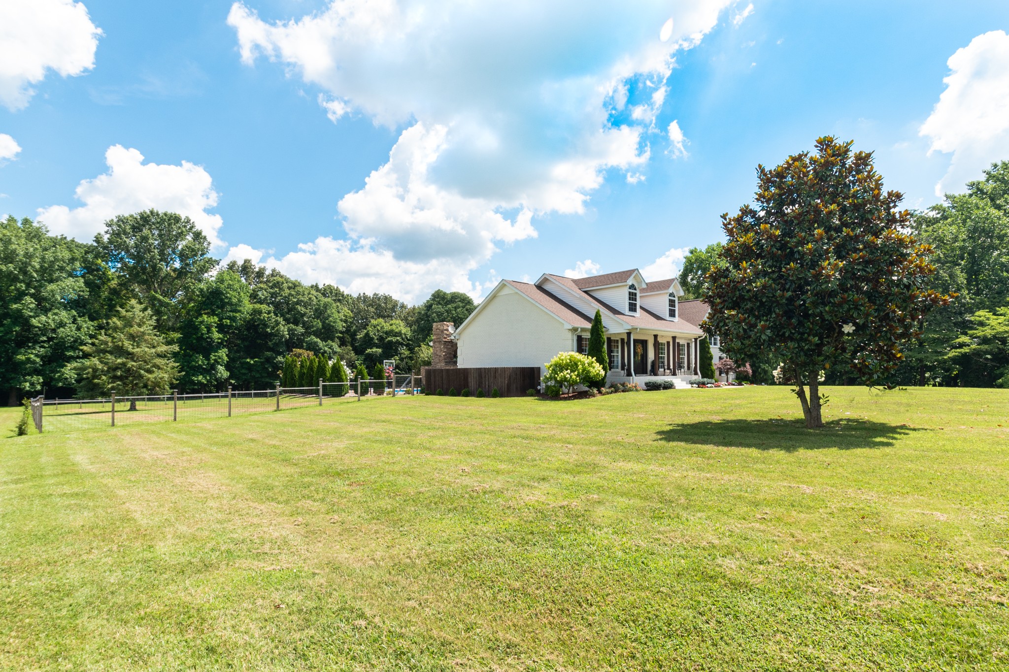 122 West Harper Road Portland, TN 37148 - Photo 3 of 74 a view of an house with pool and trees in the background
