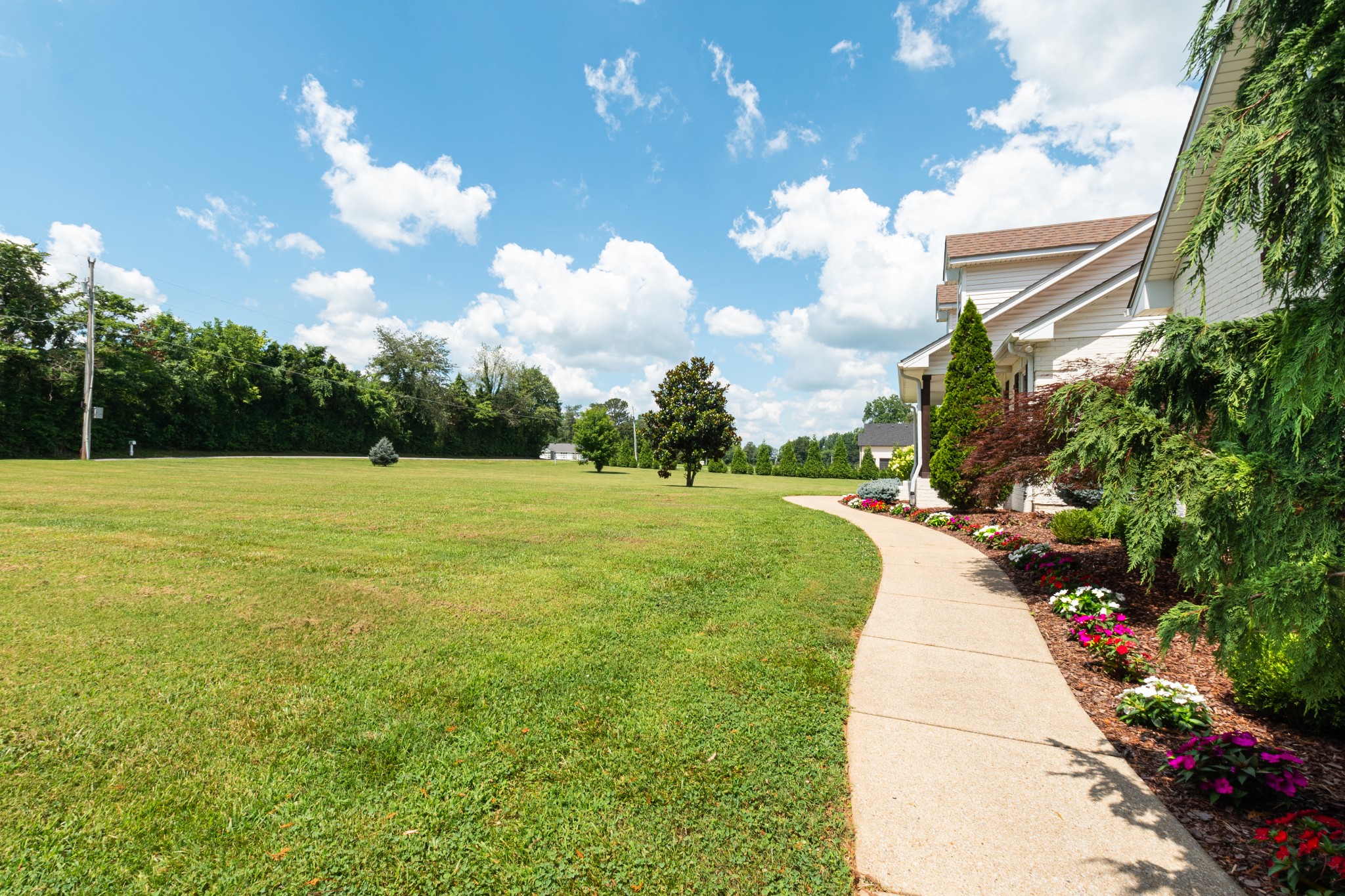 122 West Harper Road Portland, TN 37148 - Photo 5 of 74 a view of a fountain in front of a house with a big yard