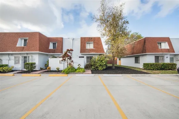 front view of a brick house with a yard