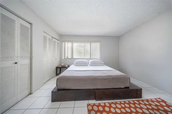 a spacious bedroom with a bed and window