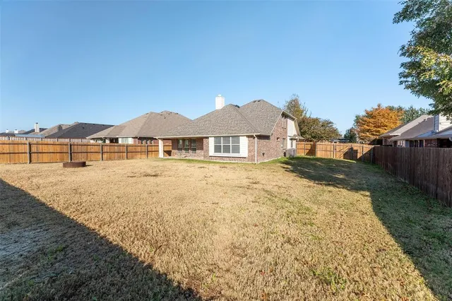 a view of a house with a yard and sitting area