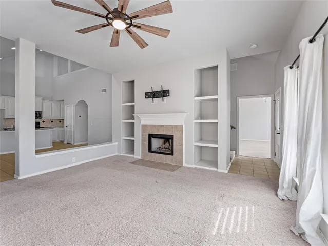 a view of a livingroom with a fireplace and window