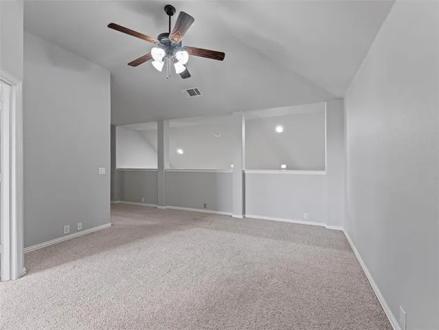 an empty room with fan and entrance