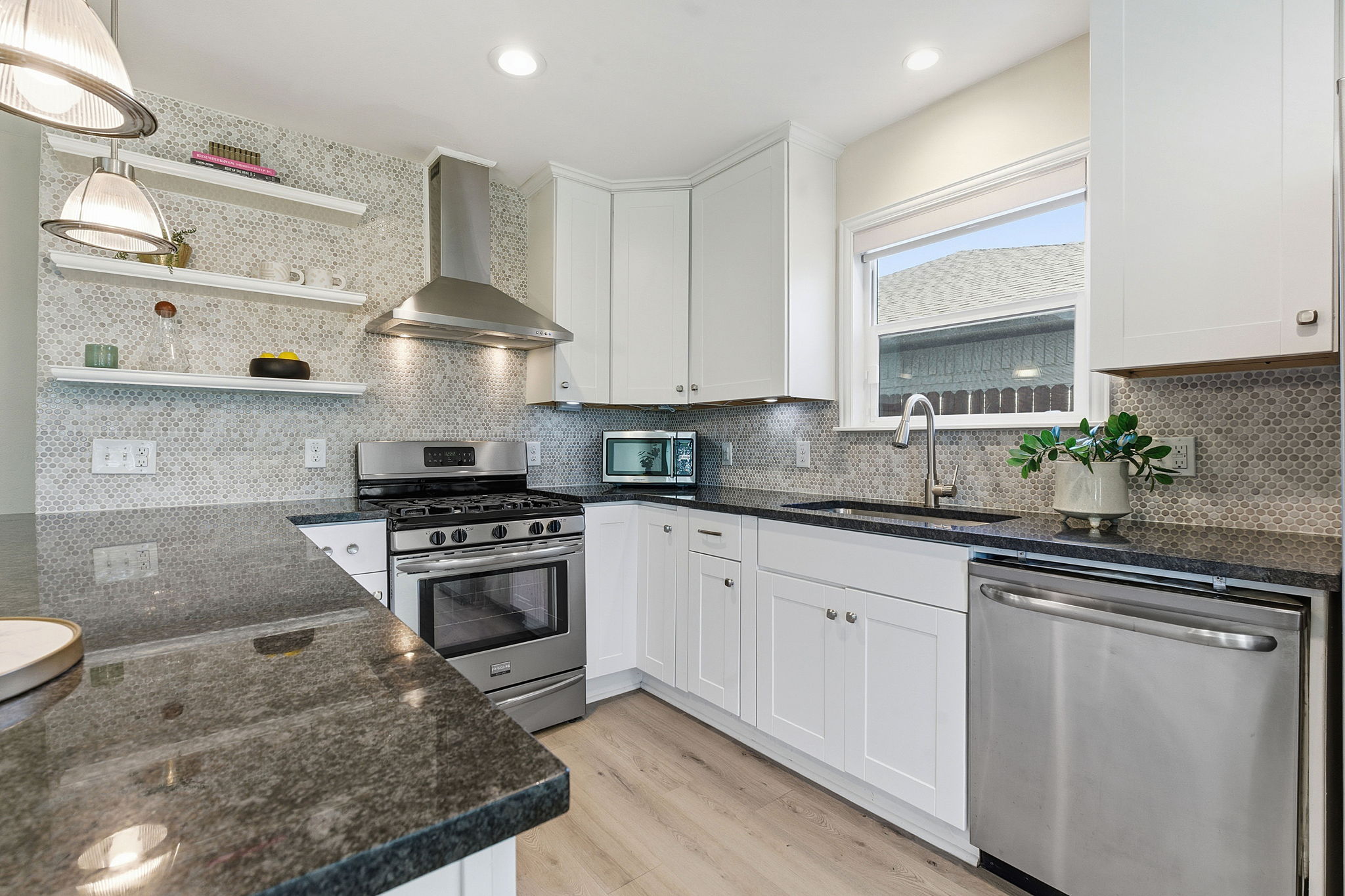 7105 Windrift Way Austin, TX 78745 - Photo 12 of 32 a kitchen with white cabinets and appliances