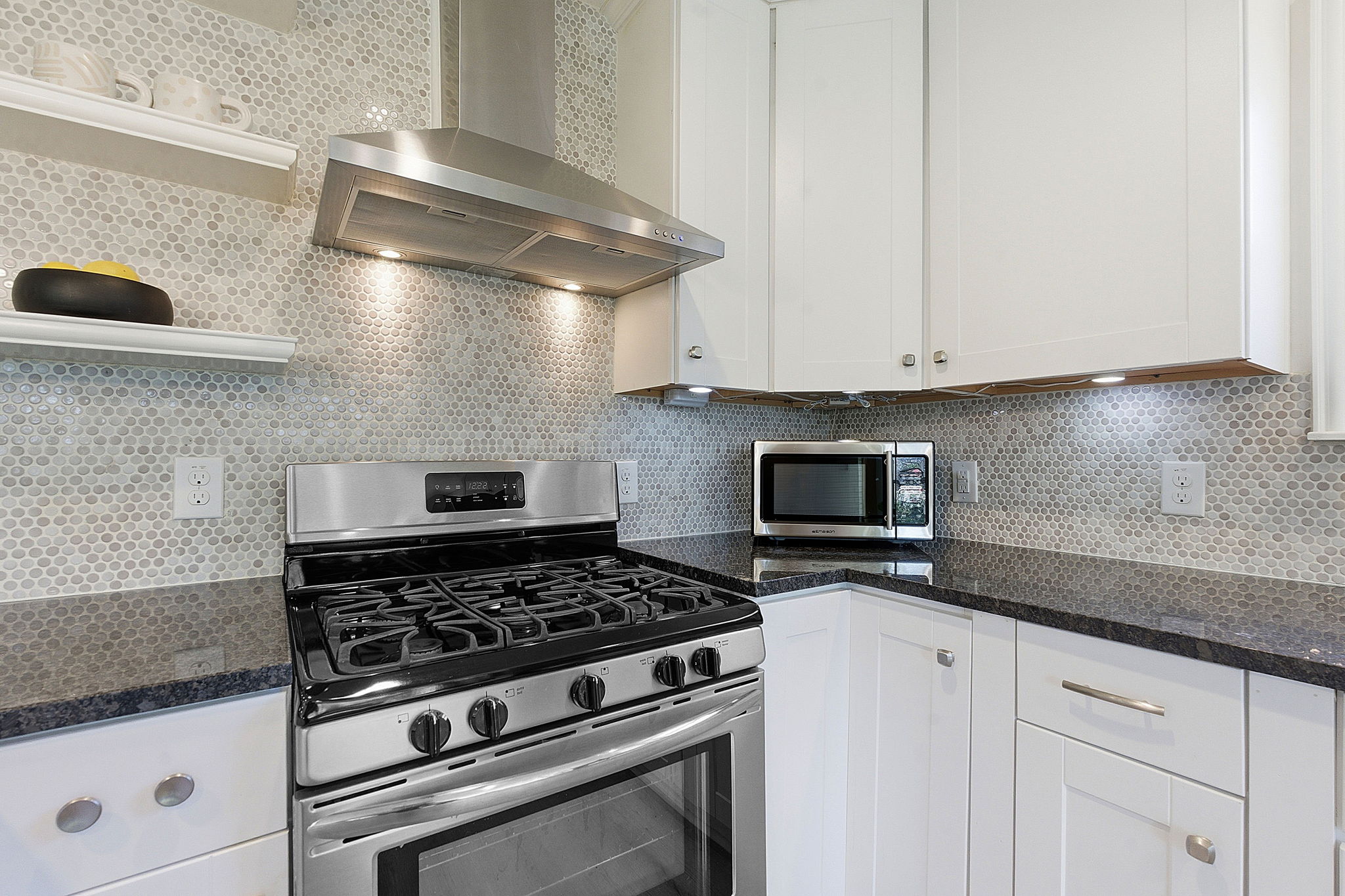 7105 Windrift Way Austin, TX 78745 - Photo 14 of 32 a stove top oven sitting inside of a kitchen