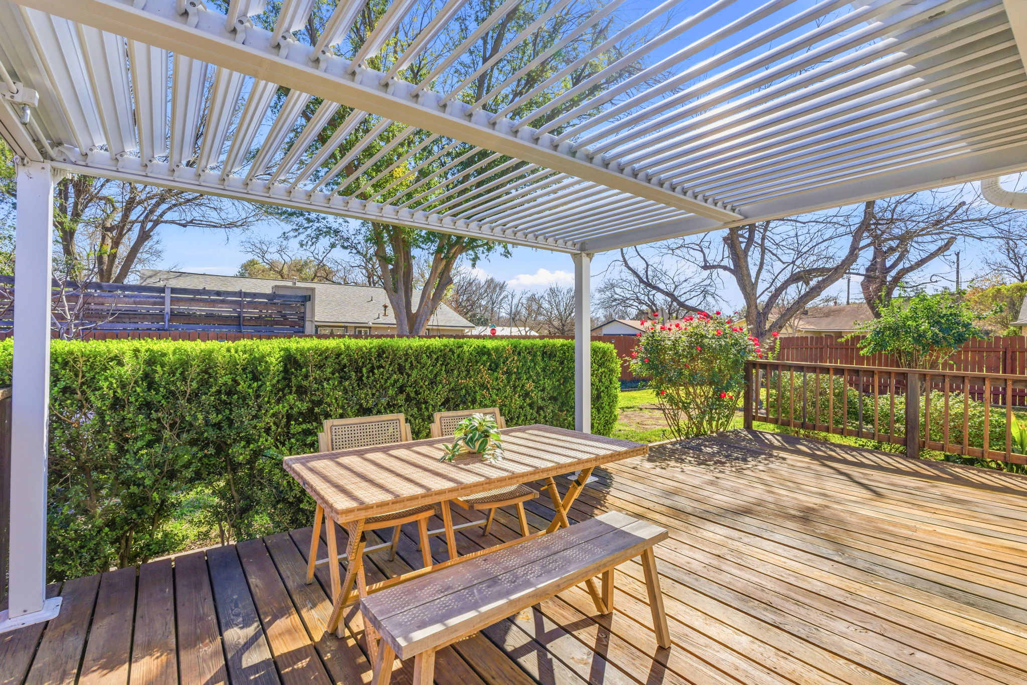 7105 Windrift Way Austin, TX 78745 - Photo 24 of 32 a view of a patio with table and chairs under an umbrella with wooden floor