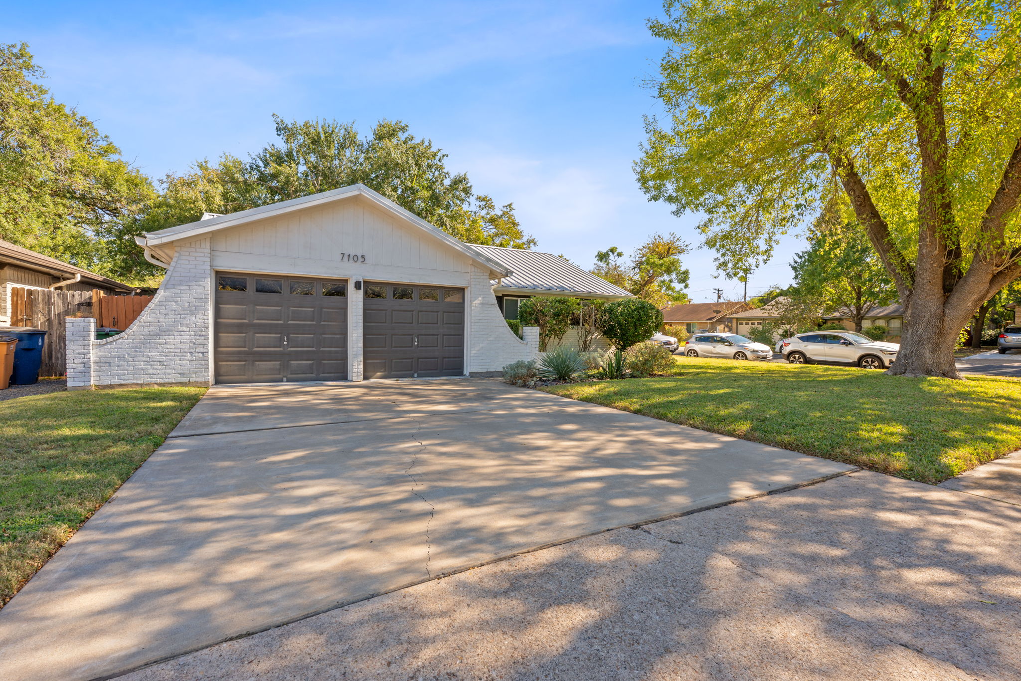 7105 Windrift Way Austin, TX 78745 - Photo 31 of 32 a front view of a house with a garden and yard