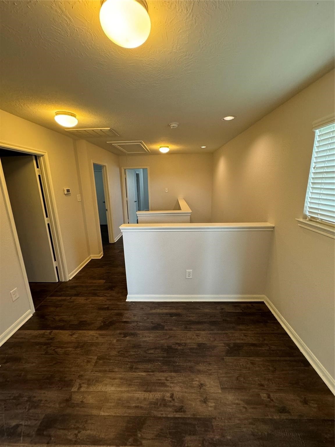 19022 Bee Line Court Houston, TX 77073 - Photo 11 of 12 a view of an empty room with wooden floor and a window