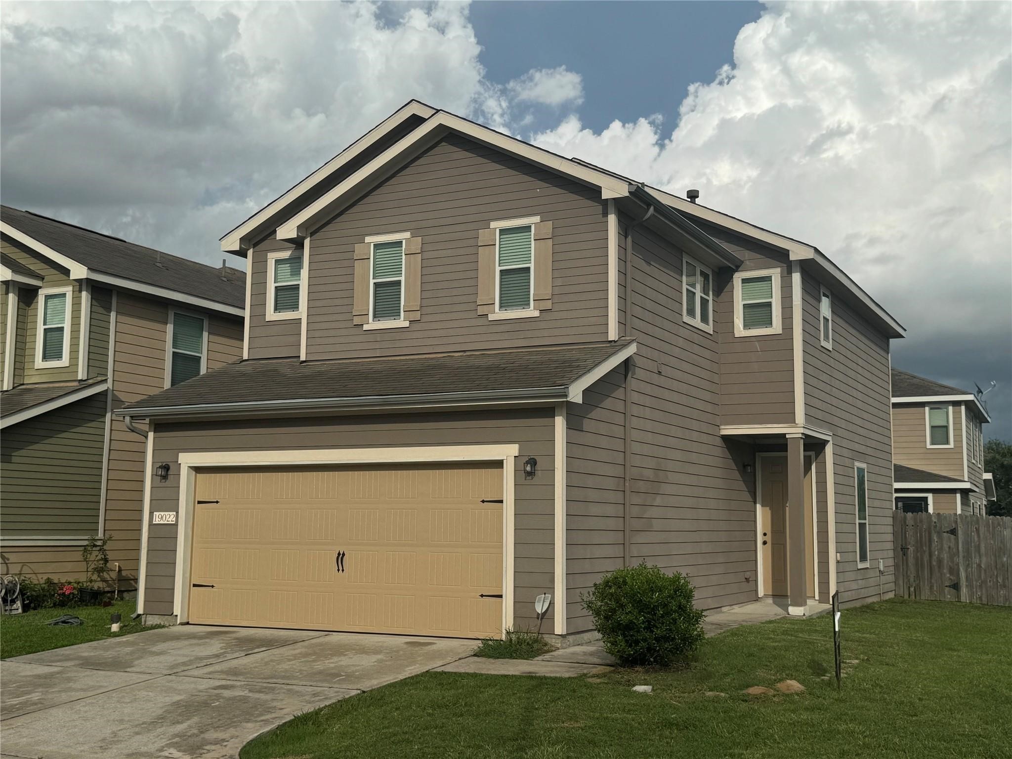 19022 Bee Line Court Houston, TX 77073 - Photo 2 of 12 a front view of a house with a yard and garage