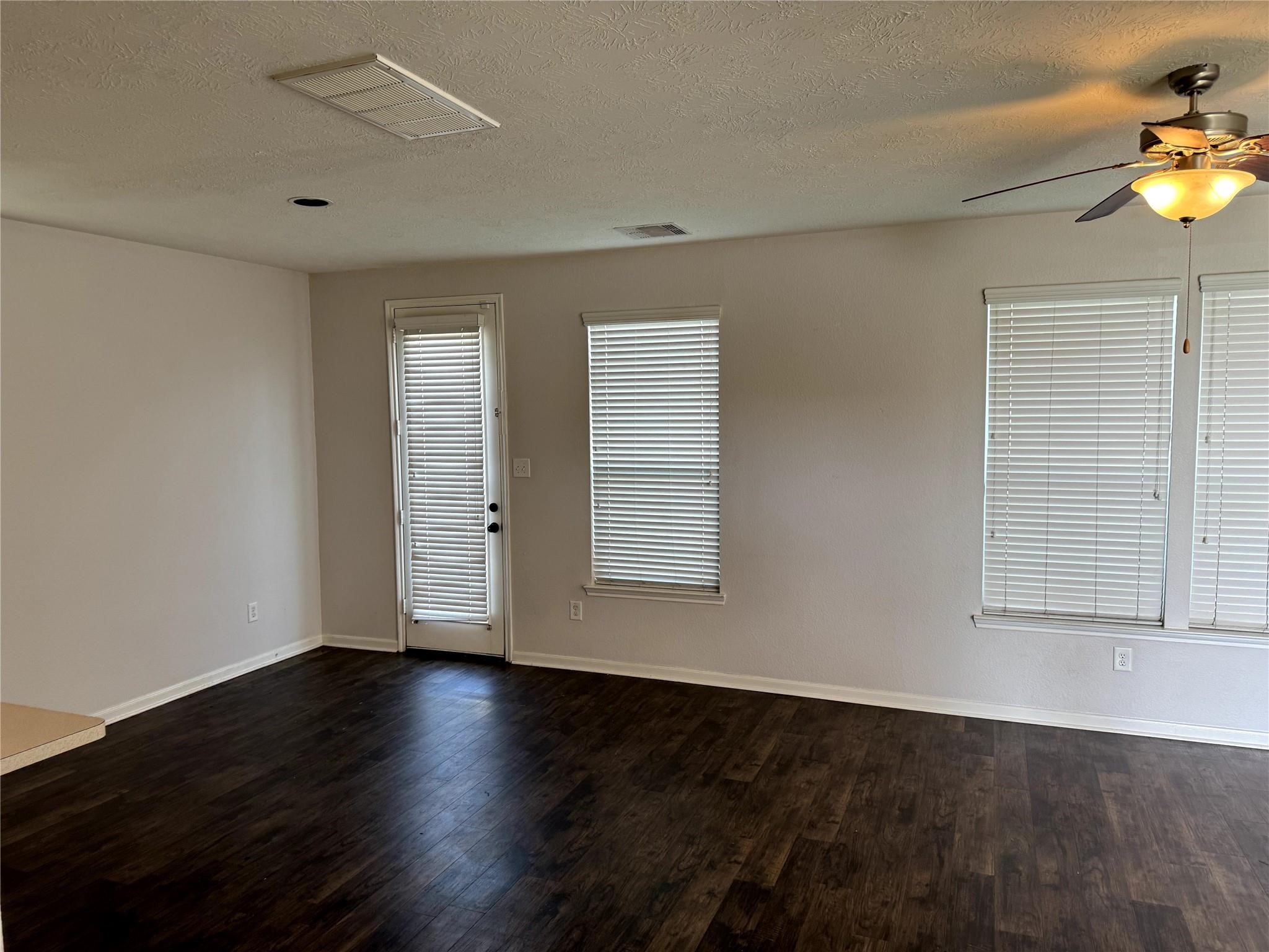 19022 Bee Line Court Houston, TX 77073 - Photo 7 of 12 an empty room with wooden floor and windows
