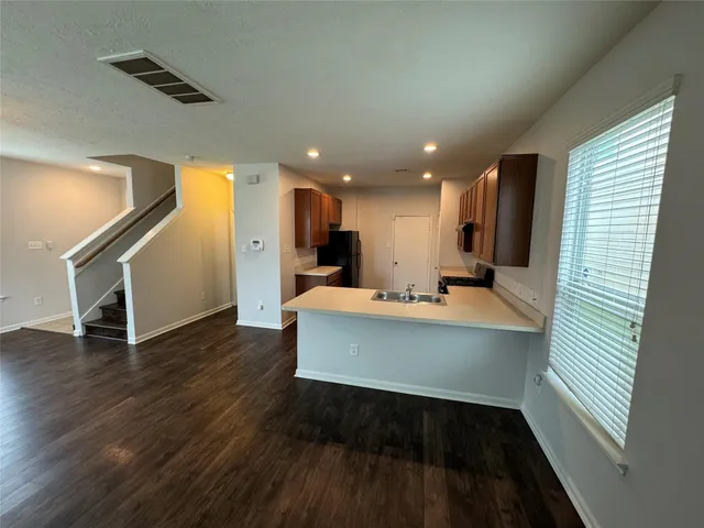 a view of kitchen with wooden floor and electronic appliances