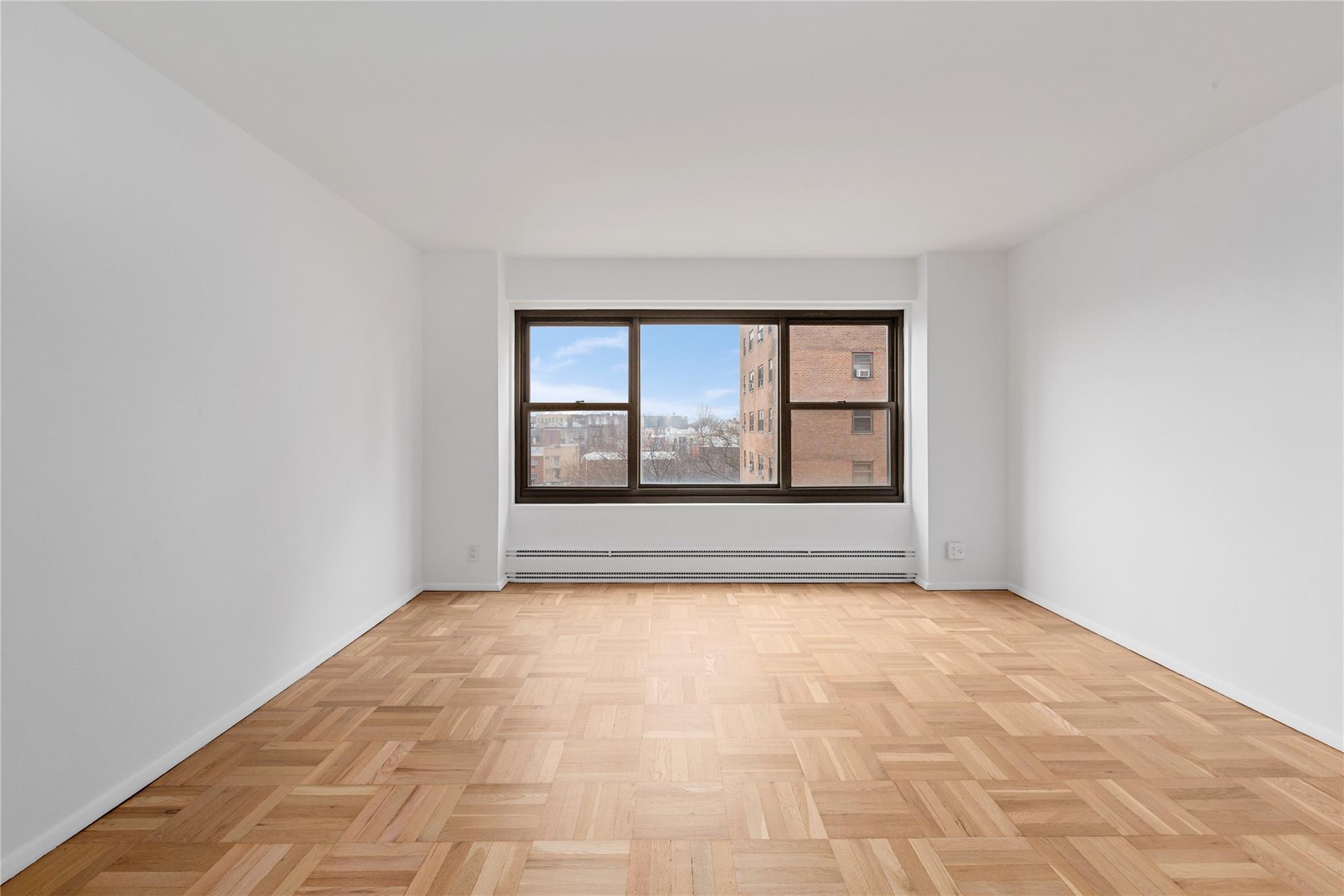 21-80 33rd Road, Unit 7D Queens, NY 11106 - Photo 2 of 12 a view of an empty room with a window