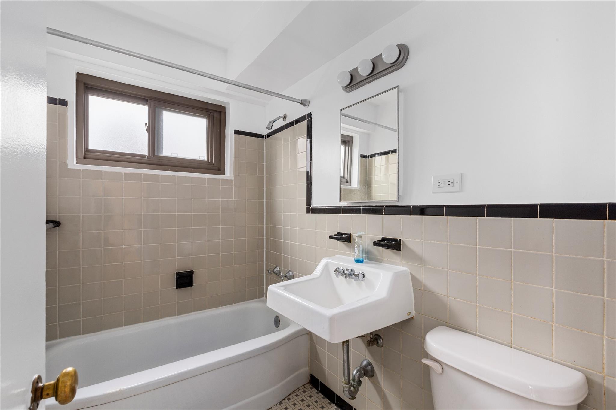 21-80 33rd Road, Unit 7D Queens, NY 11106 - Photo 7 of 12 a bathroom with a sink a toilet and shower