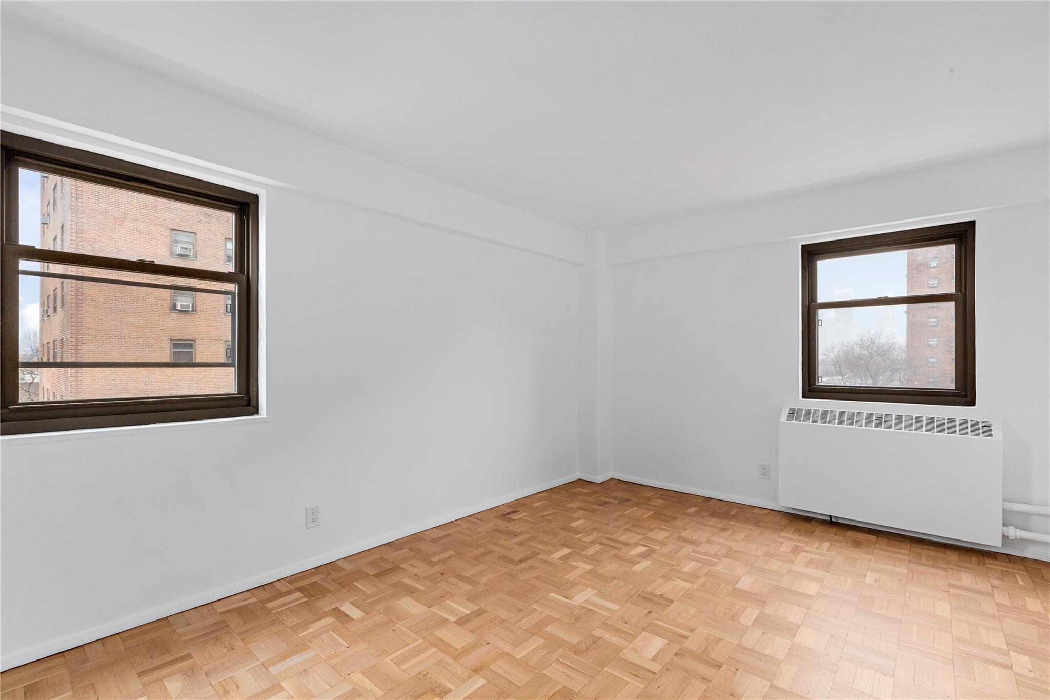 21-80 33rd Road, Unit 7D Queens, NY 11106 - Photo 8 of 12 an empty room with windows