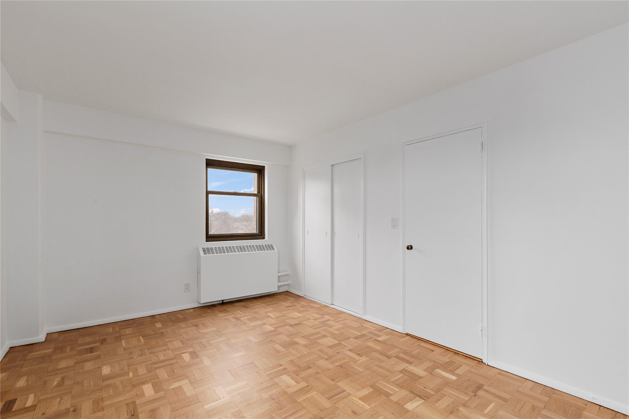 21-80 33rd Road, Unit 7D Queens, NY 11106 - Photo 9 of 12 a view of an empty room and window