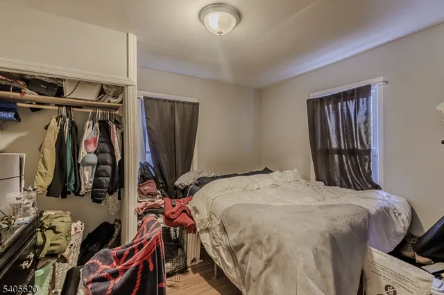 a bedroom with a bed and a television