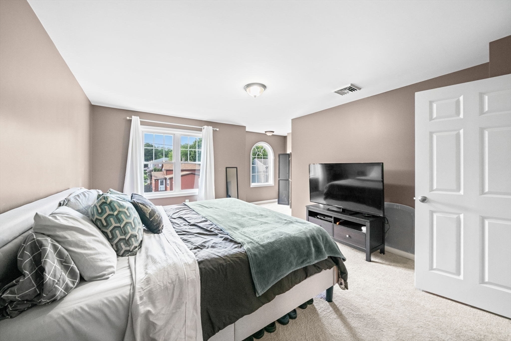 38 Renaud Street Fall River, MA 02721 - Photo 14 of 25 a bedroom with a bed and a flat screen tv