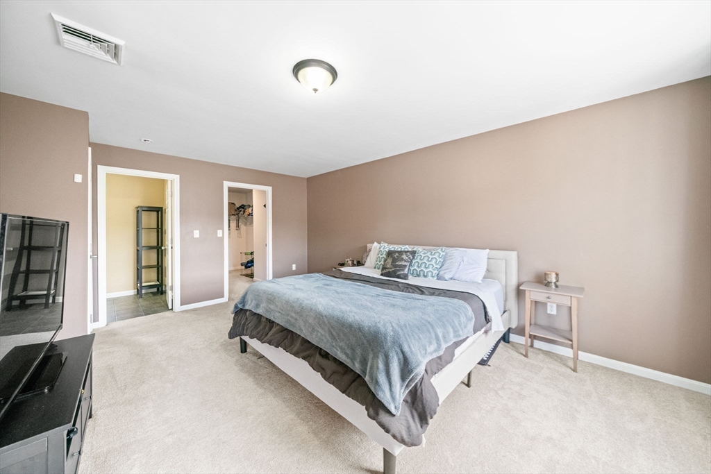 38 Renaud Street Fall River, MA 02721 - Photo 15 of 25 a spacious bedroom with a bed and a flat tv screen on the dresser