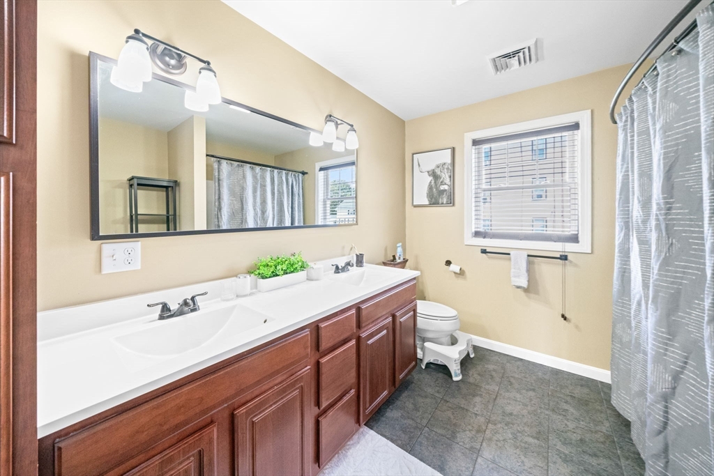 38 Renaud Street Fall River, MA 02721 - Photo 17 of 25 a bathroom with a sink a toilet and a mirror