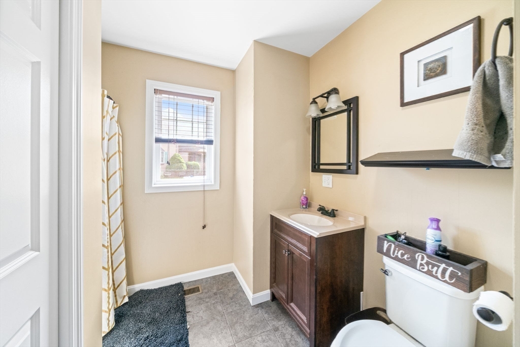 38 Renaud Street Fall River, MA 02721 - Photo 7 of 25 a bathroom with a sink mirror and toilet