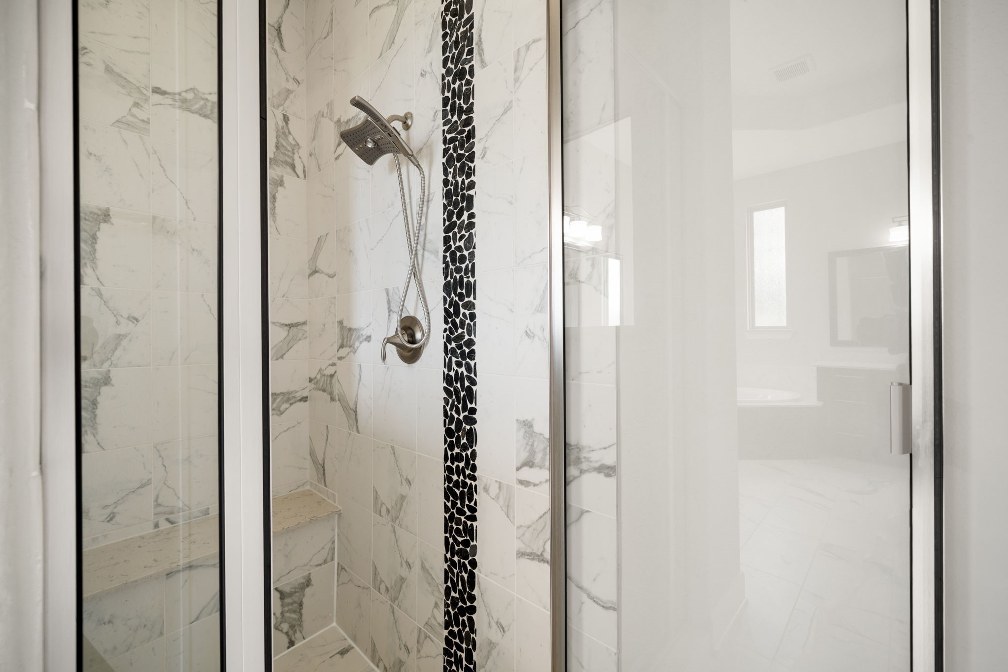 3622 Sage Hollow Drive Spring, TX 77386 - Photo 19 of 46 The primary bathroom also features a generous walk-in mud-set glass shower, beautifully finished with stone tile surrounds and a decorative accent tile band.