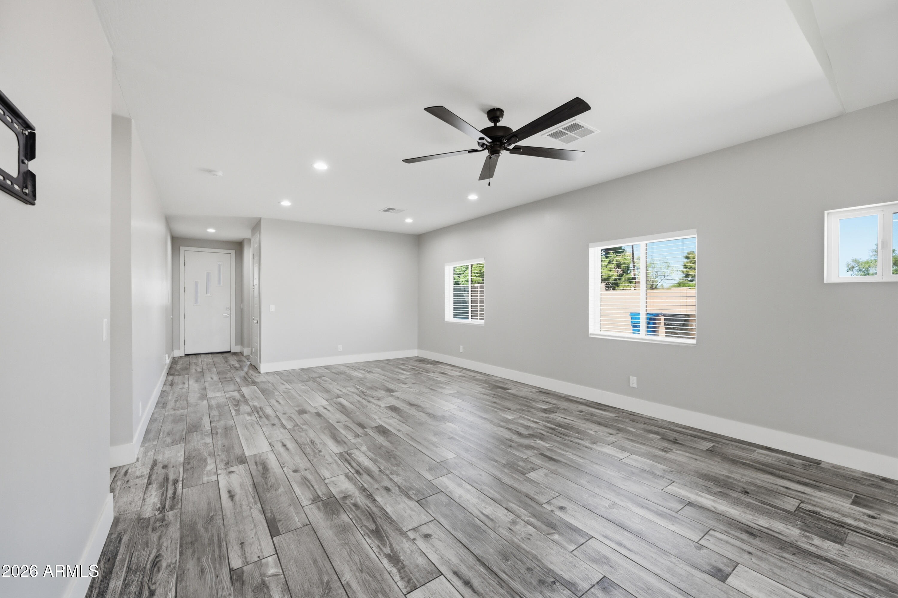 431 North Matlock Street Mesa, AZ 85203 - Photo 4 of 33 a view of empty room with wooden floor and fan