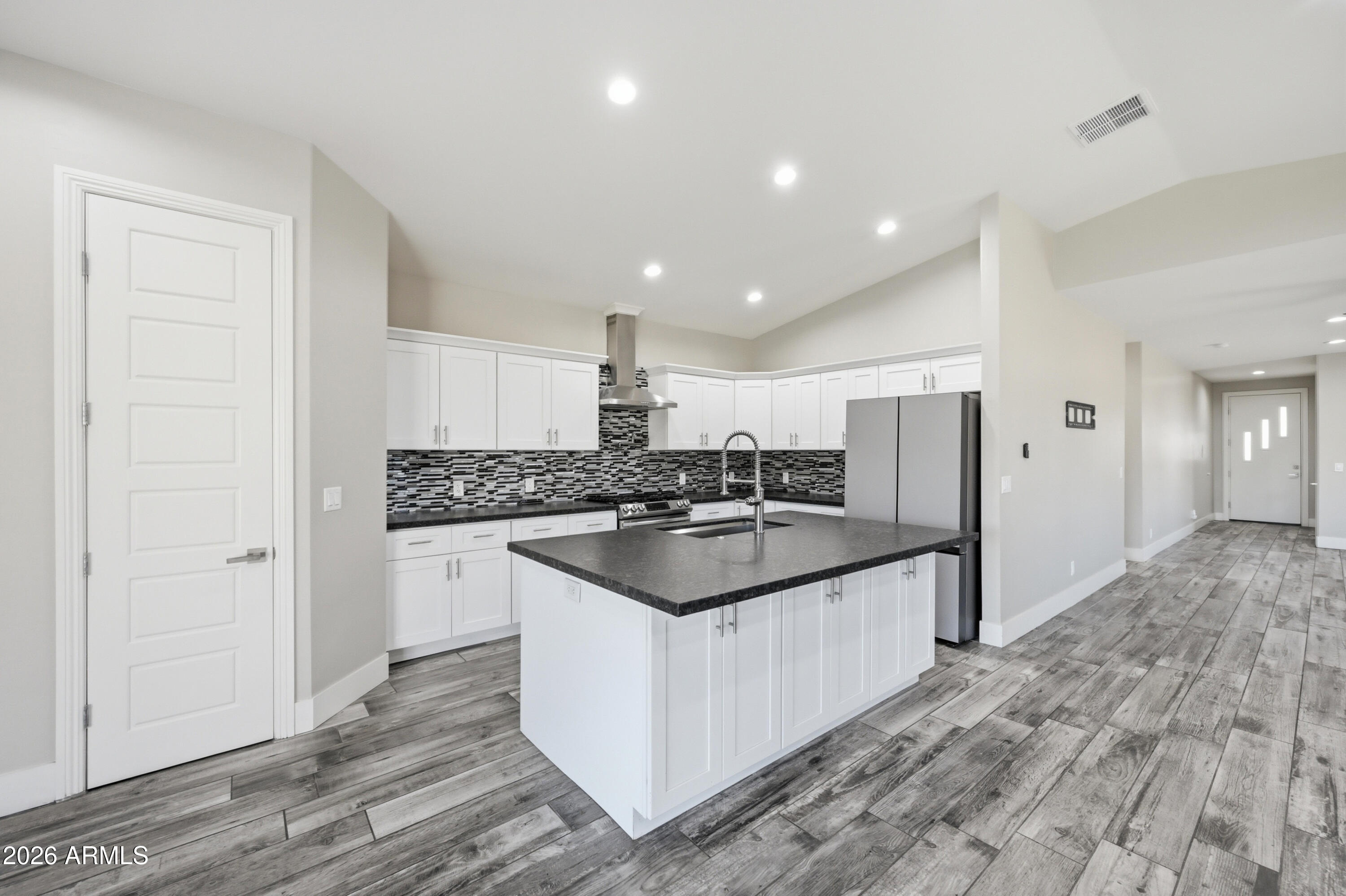 431 North Matlock Street Mesa, AZ 85203 - Photo 7 of 33 a kitchen with stainless steel appliances granite countertop a sink and a stove top oven