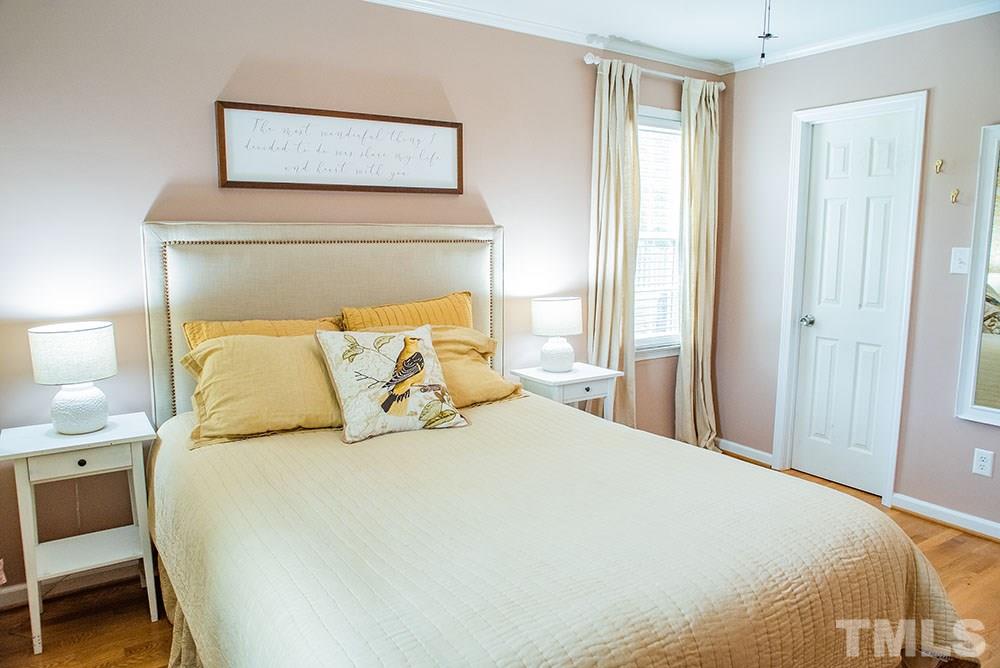 2266 Thee Hester Road Roxboro, NC 27574 - Photo 14 of 29 a large bed in a bedroom next to a window and a lamp