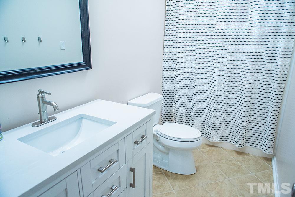 2266 Thee Hester Road Roxboro, NC 27574 - Photo 22 of 29 a bathroom with a sink a toilet and mirror