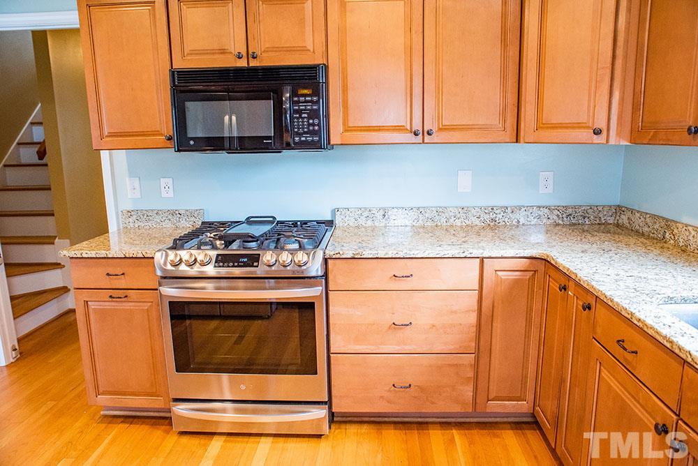 2266 Thee Hester Road Roxboro, NC 27574 - Photo 8 of 29 a kitchen with stainless steel appliances granite countertop a sink and a stove