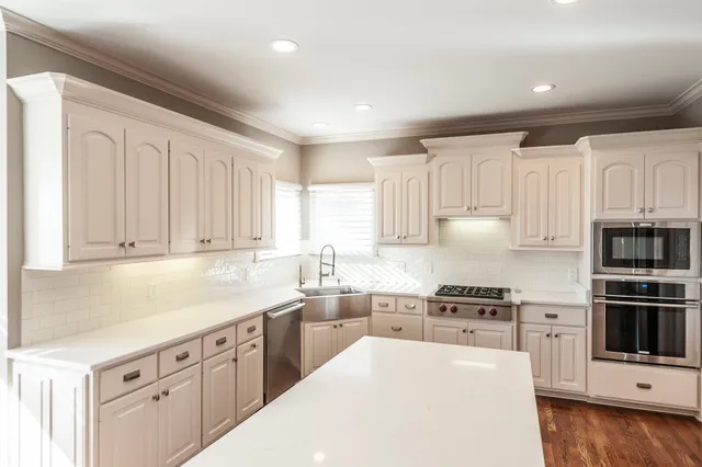 a bedroom with a bed and a flat tv screen on the dresser