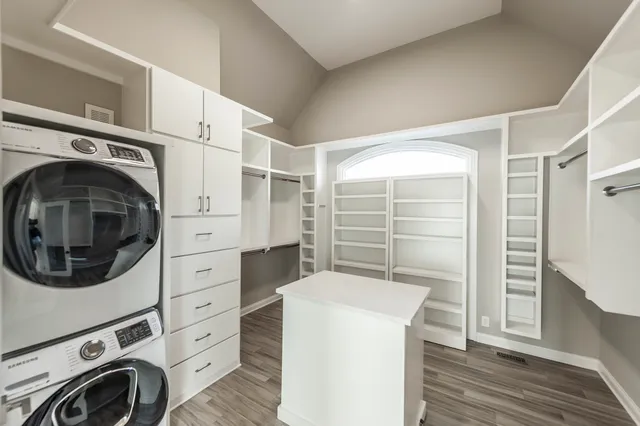 a room with furniture a flat screen tv and a refrigerator