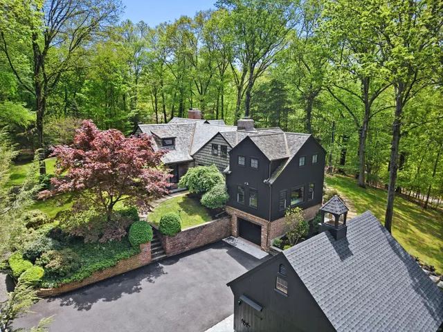 an aerial view of a house with a yard