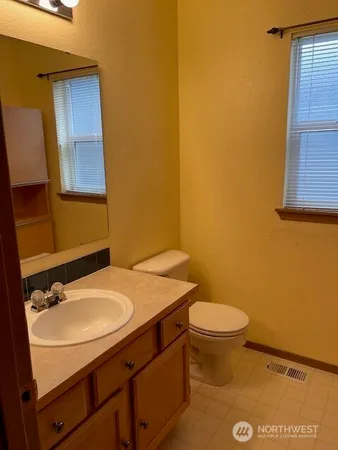 a bathroom with a sink toilet and mirror