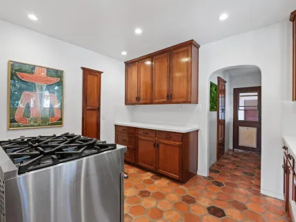 a kitchen with a sink a window and cabinets