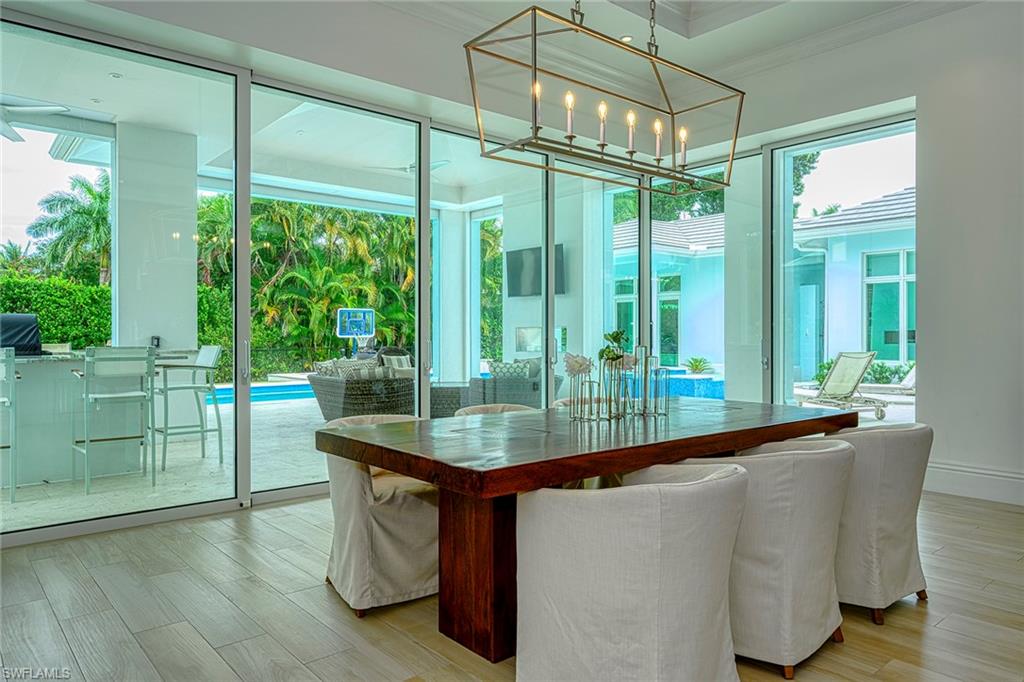 655 Riviera Drive Naples, FL 34103 - Photo 7 of 34 Generous Dining overlooking pool and spa!