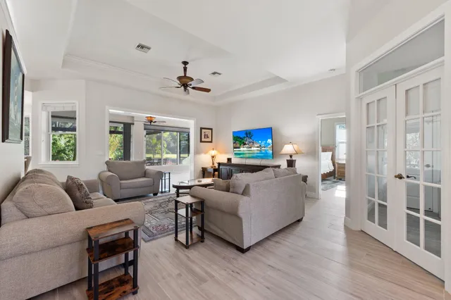 a living room with furniture and a wooden floor