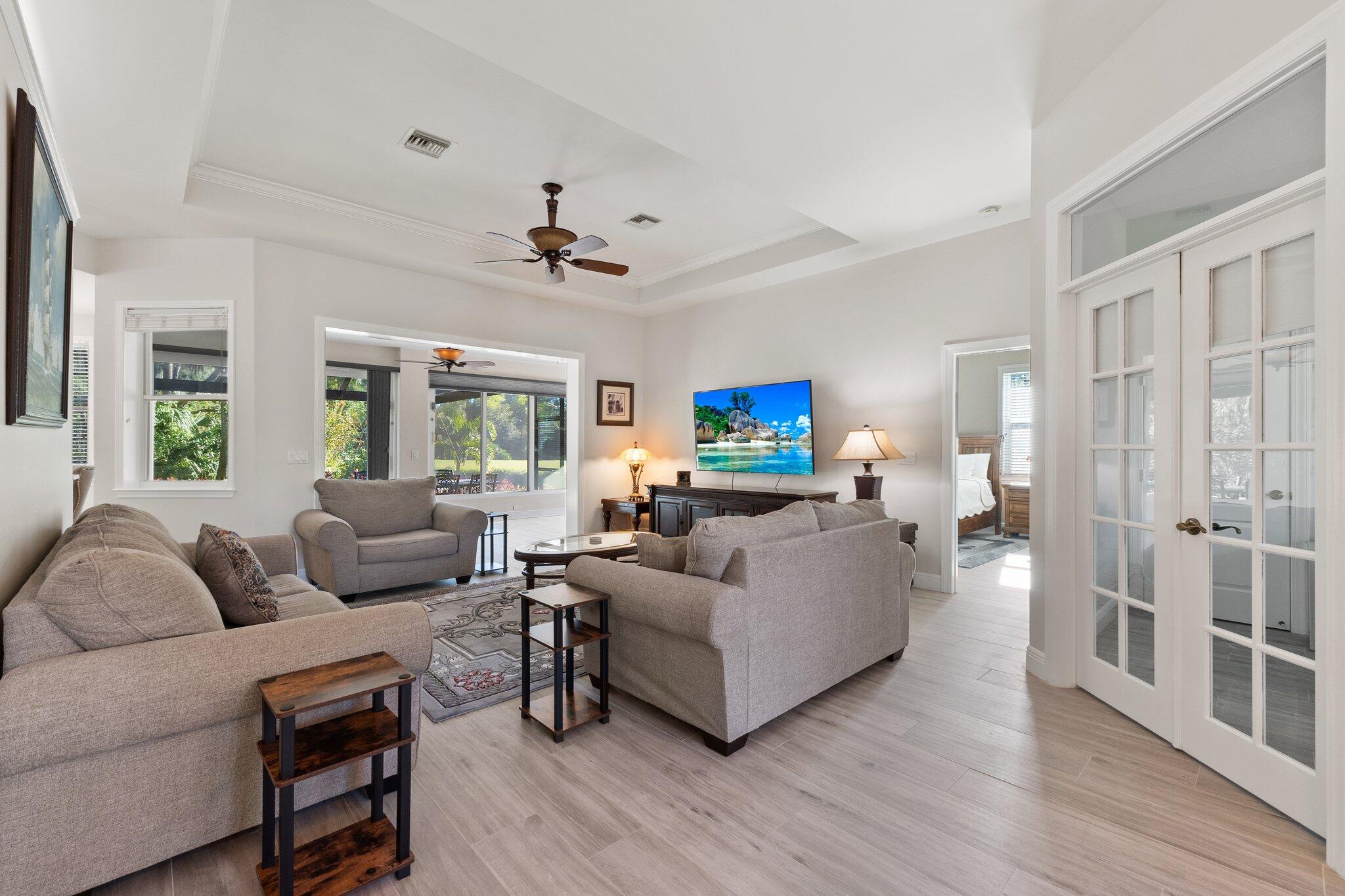 1680 Southeast Cypress Glen Way Stuart, FL 34997 - Photo 13 of 76 a living room with furniture and a flat screen tv