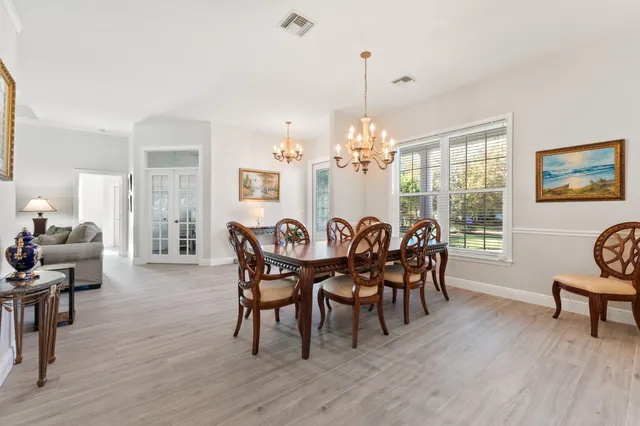 a view of a dining room with furniture wooden floor and chandelier
