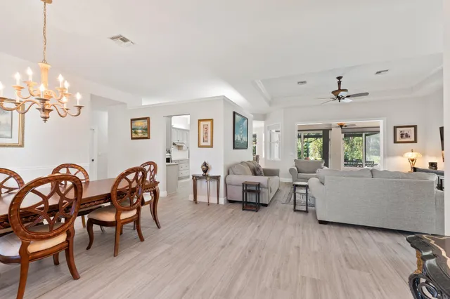 a view of a livingroom with furniture wooden floor and a floor to ceiling window