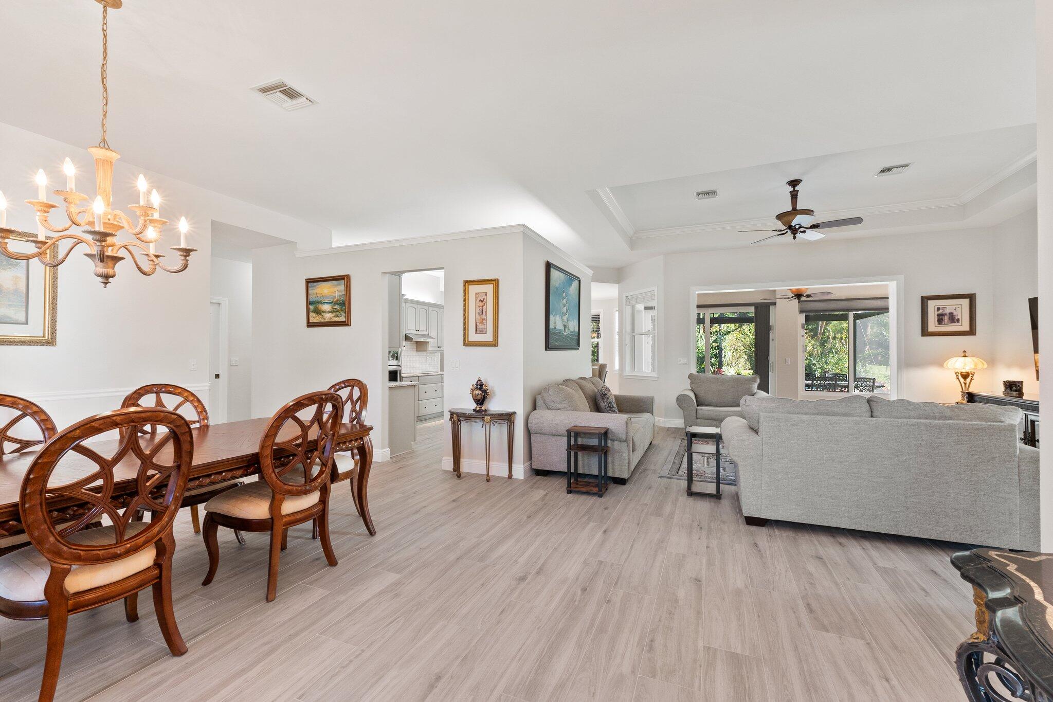 1680 Southeast Cypress Glen Way Stuart, FL 34997 - Photo 19 of 76 a living room with furniture and a wooden floor