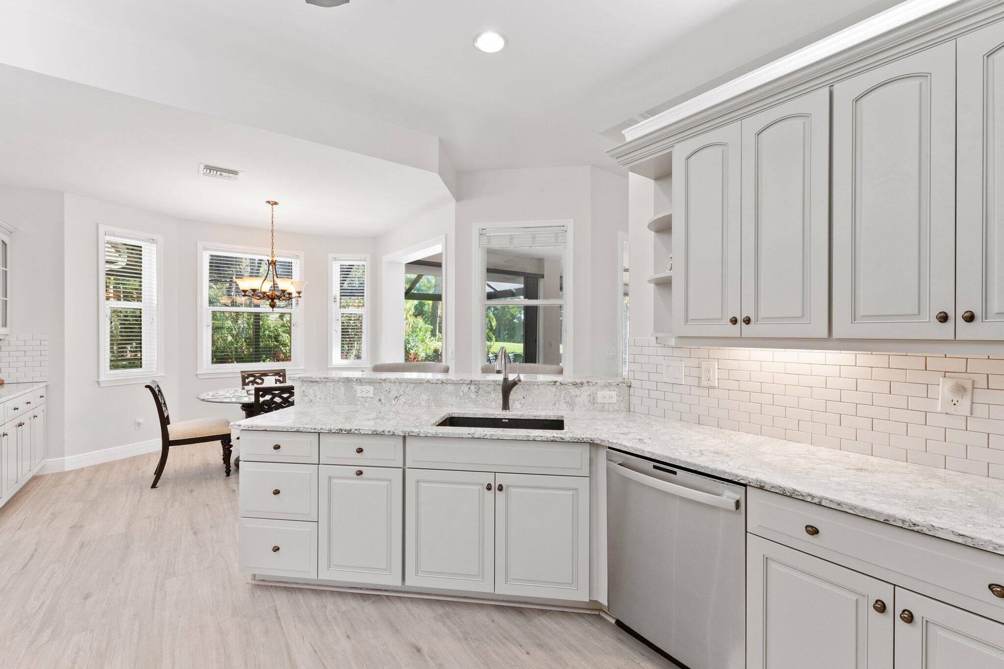 1680 Southeast Cypress Glen Way Stuart, FL 34997 - Photo 24 of 76 a kitchen with a sink and cabinets