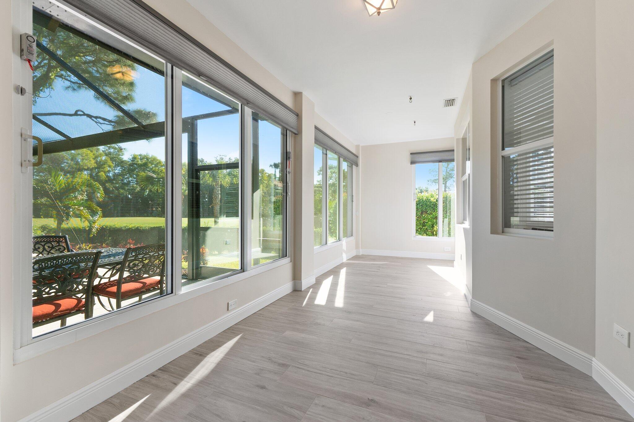 1680 Southeast Cypress Glen Way Stuart, FL 34997 - Photo 28 of 76 a view of an entryway with wooden floor and windows