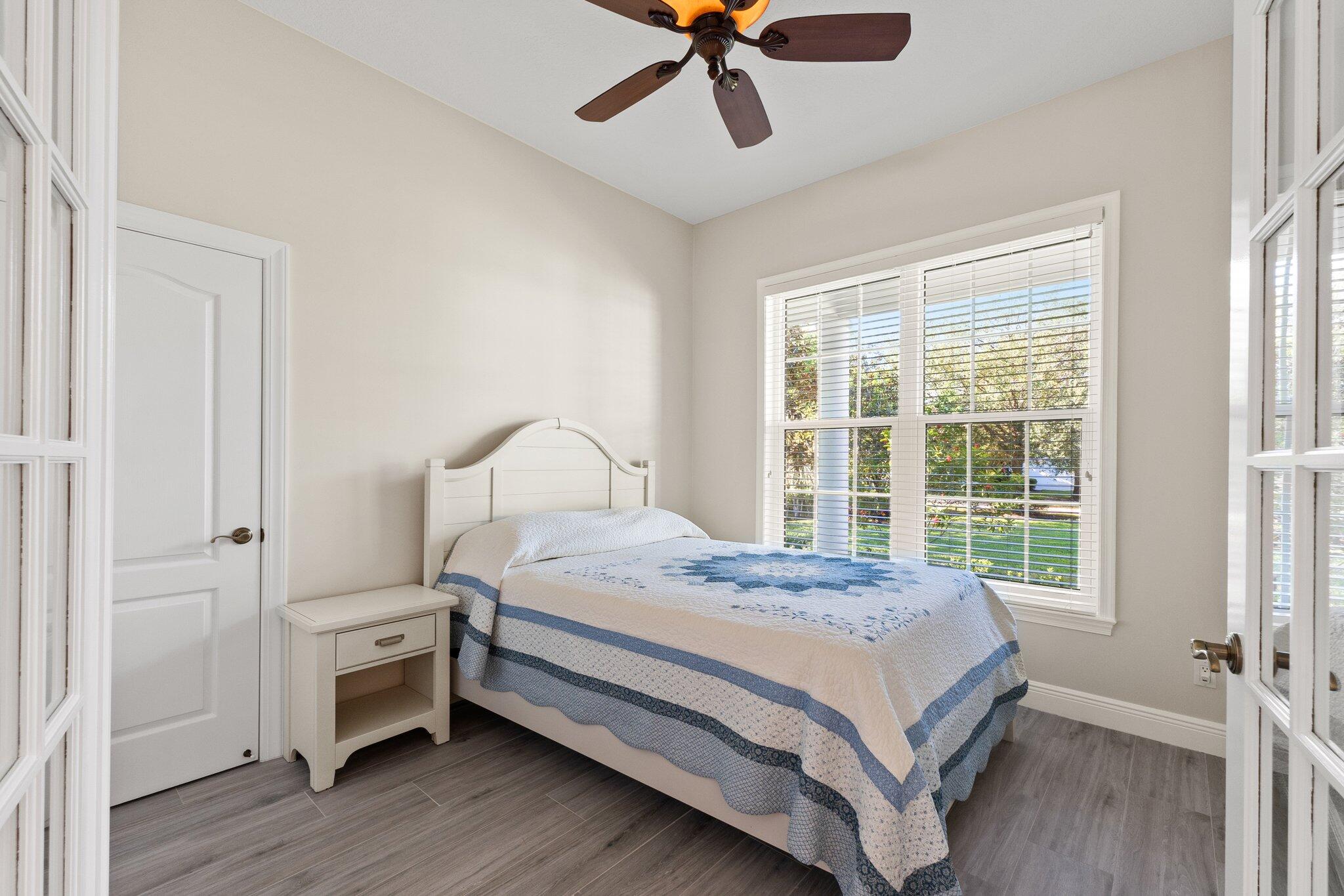 1680 Southeast Cypress Glen Way Stuart, FL 34997 - Photo 31 of 76 a bed room with a bed and a window