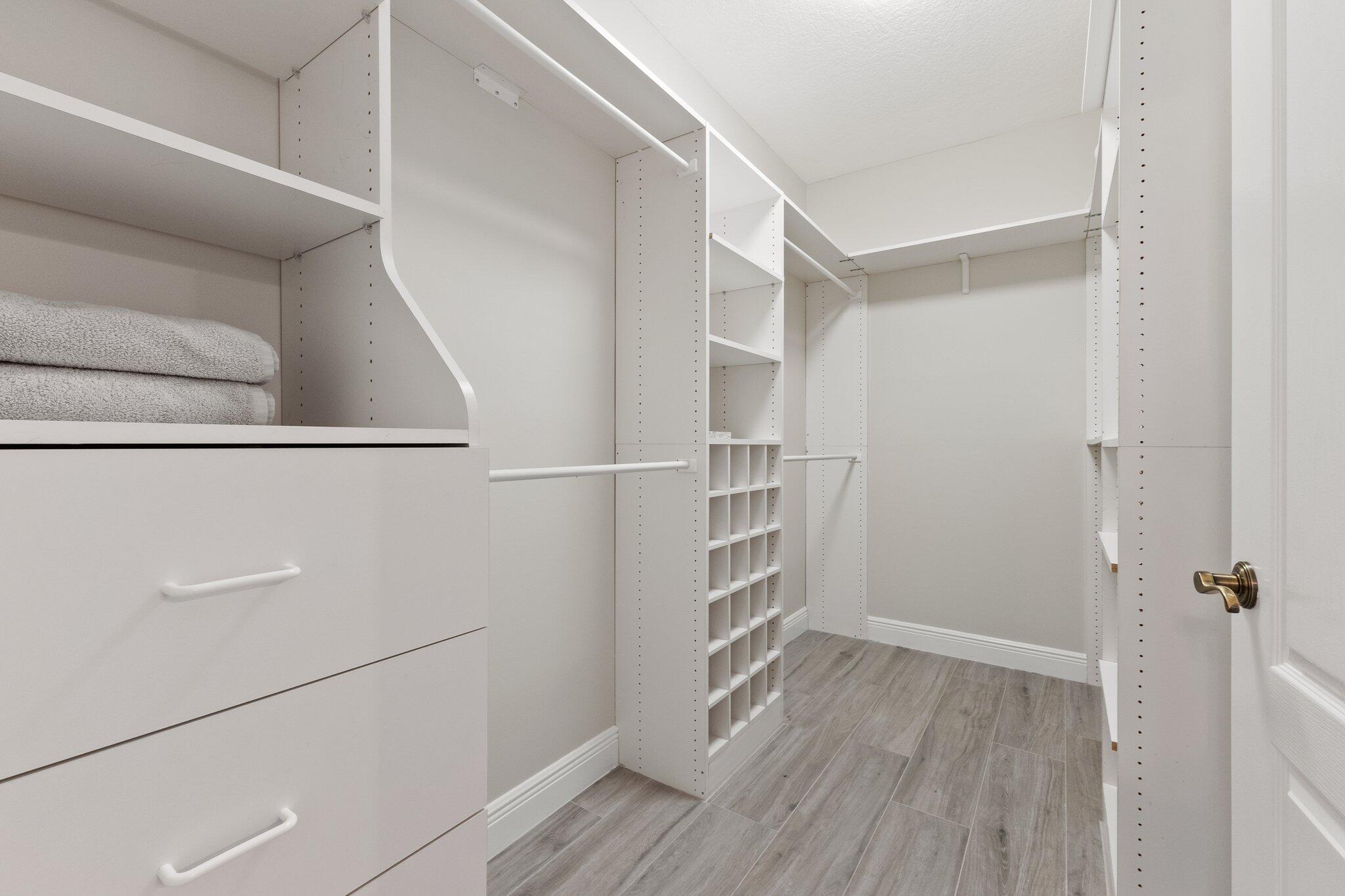 1680 Southeast Cypress Glen Way Stuart, FL 34997 - Photo 38 of 76 a view of walk in closet with empty racks