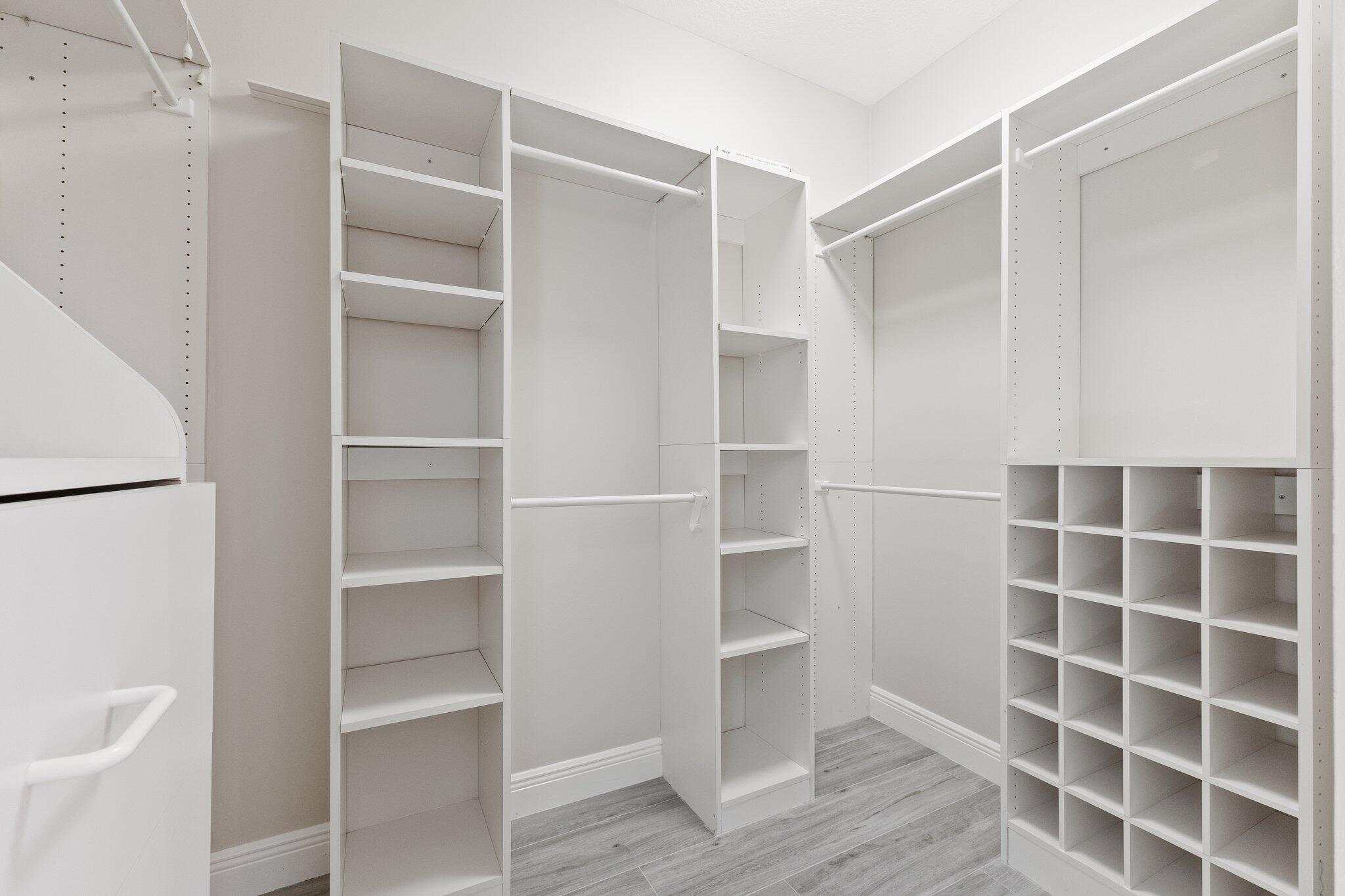 1680 Southeast Cypress Glen Way Stuart, FL 34997 - Photo 42 of 76 a view of walk in closet with empty racks